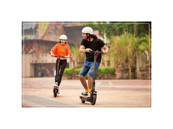 man and a girl are riding yadea ks5 pro electric scooter